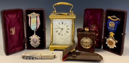 A miniature Swiss traveling clock timepiece, leather case; Mappin & Webb carriage clock; leather