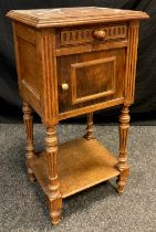 An early 20th century oak pot cupboard, rouge marble top, single short drawer to frieze, above a