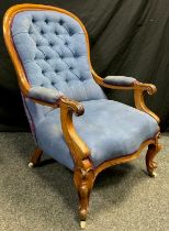 A Victorian mahogany armchair, button-back, scroll arms, sprung seat, serpentine shaped front,