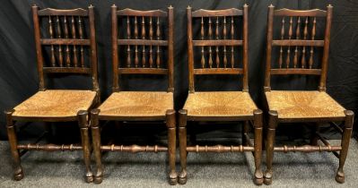 A set of four oak and elm spindle-back, rush-seated chairs, 105cm high x 49cm wide, (4).