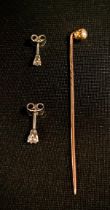 A diamond tipped Tie pin, old brilliant cut, approx. 0.25ct, spiralled rose metal shaft, 1.1g gross,