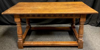 A Titchmarsh and Goodwin style oak dining table, thick rectangular oak top, turned supports, 74cm