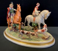 A large Capodimonte figure group, by Falchi, as Huntsman and Huntswoman riding with two hounds,