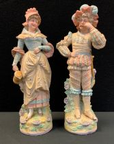 A pair of 19th century continental bisque porcelain figures, as Dandy Swordsman and companion,