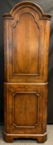 A reproduction walnut veneered corner cupboard, arch-top, 181cm high x 61cm wide.