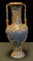 A Mettlach baluster two handled vase decorated with foliate scrolls in ochre, on a grey ground,