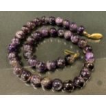 A blue john globular bead necklace, with forty deep colour tone globular beads, approx 9mm diameter,