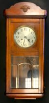 A 1930s oak cased wall clock, silvered dial, Arabic numerals, approx 8cm high