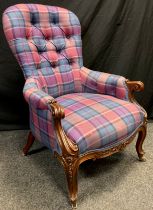 A Victorian walnut armchair, button-back, scroll arms, carved cabriole legs, brass casters, 104cm