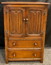 A mid 20th century oak side cupboard, by Goodall's furniture of Manchester, over-sailing rectangular