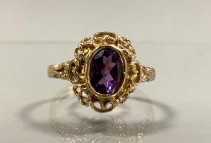 An oval amethyst dress ring, scrolling heart and rope twist mount, 9ct gold shank, size O, 3.5g