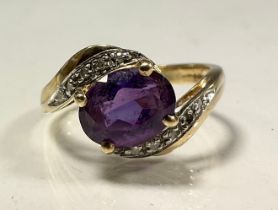 An amethyst and cz dress ring, twisting crest, 9ct gold shank, size K, 2.3g gross