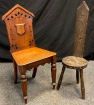 A late 19th century walnut hall chair, architectural shaped back with pierced design, tapered