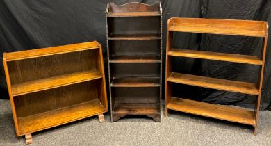 A Mid 20th century dark oak open bookcase, of narrow proportions, shaped three-quarter galleried