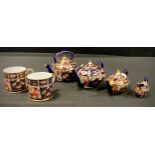 Royal Crown Derby - a miniature 6299 pattern three piece tea set, larger teapot, oval teapot, milk