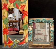 An Alan Wallis designed hand crafted wall mirror, scumble effect frame with ribbon bow crest and