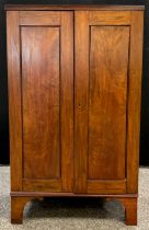 A Victorian mahogany hall cupboard, pair of doors enclosing three tiers of shelving, bracket feet,