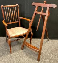 A Victorian mahogany easel, 97cm high x 52.5cm wide; an Edwardian armchair, (2).