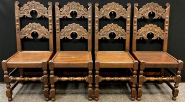 A set of four Frank Pratt of Derby, 17th century style, carved oak dining chairs, shaped cresting