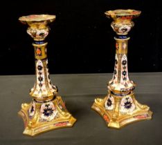 A pair of Royal Crown Derby Castleton 1128 pallet candlesticks, square base, Dolphins to angles, 27c