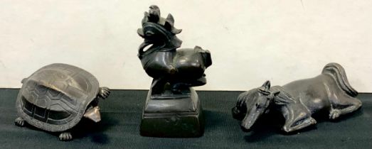 A Chinese bronze opium weight, the top as a mythical beast; two similar articulated animal locks,