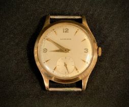 A 1950s Garrard 9ct gold cased wristwatch head, 30mm diameter case, silvered dial, Arabic numeral