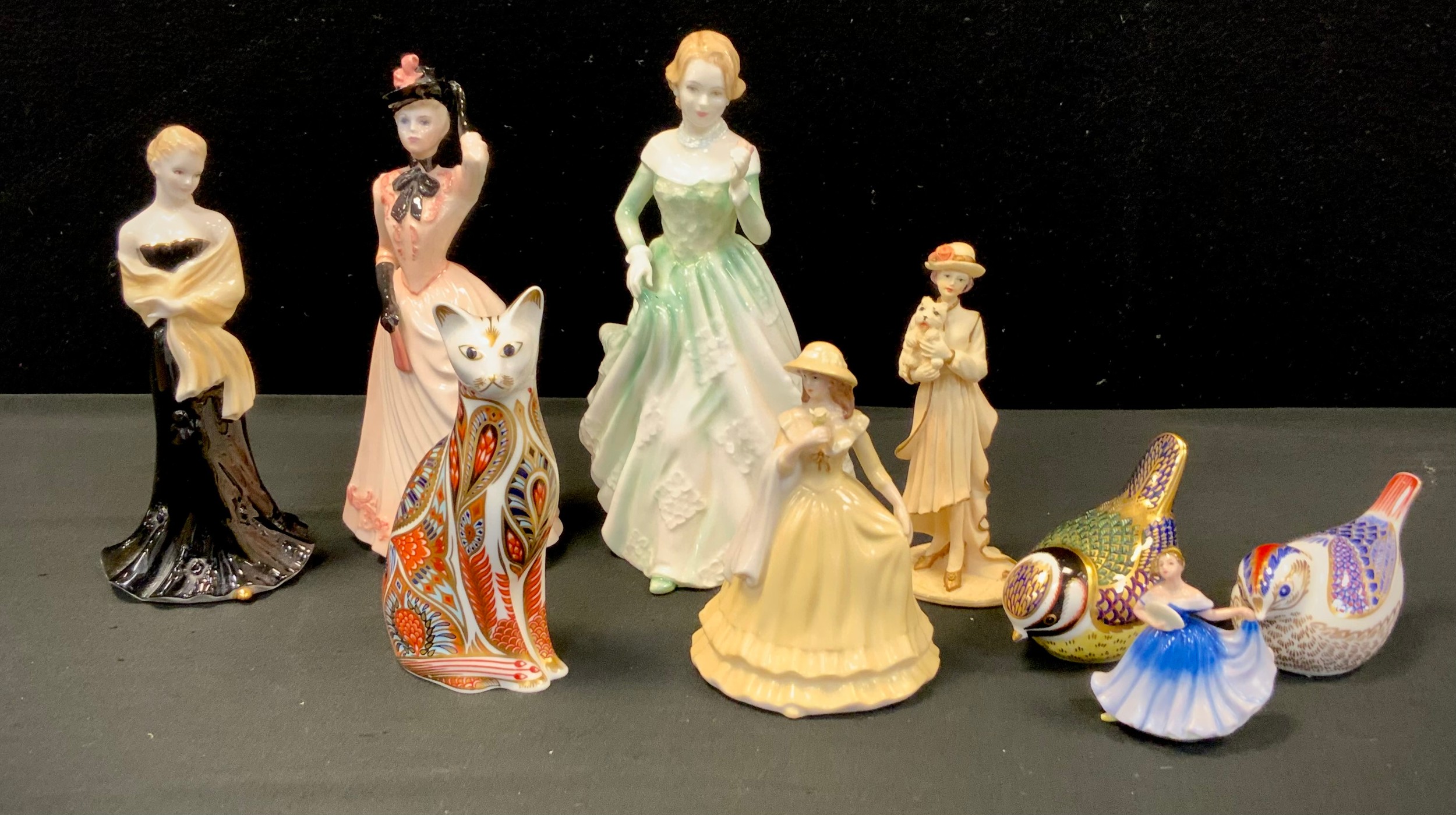 A Royal Crown Derby cat, Gold crest and Blue tit, all silver stoppers, A Royal Doulton figure ‘