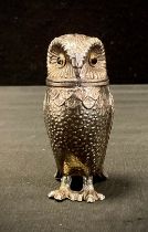 A Novelty silver coloured metal peper pot, as an Owl, 8cm high