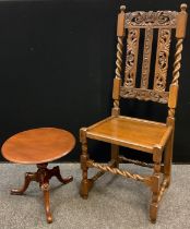 A carved oak hall chair, cresting rail and splats carved with leafy scrolls, barley twist supports