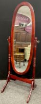 A 20th century oval framed cheval mirror, 150cm hgh, 52cm wide