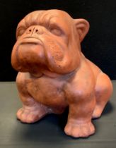 A large terracotta model as a seated Bulldog, 39cm high, 50cm long, 29cm wide.