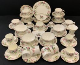 A Wedgwood ‘Hathaway rose’ part table service including six tea cups and saucers, four soup tureens,