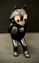 A 1930s hollow cast figure of "Felix the Cat", standing resting on his tail, with glass eyes, 25cm