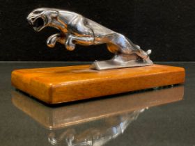 A Jaguar Car mascot, 12.5cm long, wooden plinth base.