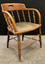 An early 20th century oak bentwood armchair, spindle back, leather seat, turned stretchers and legs,