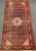 A Persian Bidjar rug, hand-knotted with a central diamond-shaped medallion with stylised flowers,