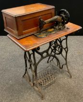 A cast iron Singer sewing machine, on cast iron treadle base, early 20th century, (number 216735 /