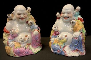 A pair of Chinese porcelain figures, each as Hoti and children, 25cm high (2)