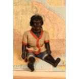 An early 20th century black composition jointed doll, painted features, black flock type hair,