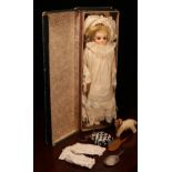 A bisque shoulder head doll, the bisque shoulder head inset with fixed brown glass eyes, painted