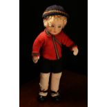 A 1920's Chad Valley doll, the moulded felt face with painted features and inset blue glass eyes,