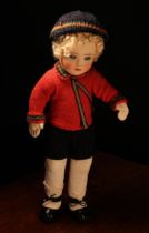 A 1920's Chad Valley doll, the moulded felt face with painted features and inset blue glass eyes,