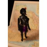An early 20th century black composition jointed doll, painted features, black flock type hair,