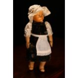 An early 20th century Swiss carved wooden head doll, probably produced in the Brienz Region by