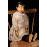 Folk Art - a large carved wooden shoulder head and partially stuffed cloth bodied doll, probably
