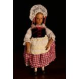 A Swiss carved wooden doll, probably produced in the Brienz Region, the carved wooden head with