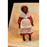 An early 20th century black composition jointed doll, painted features, black flock type hair, 18.