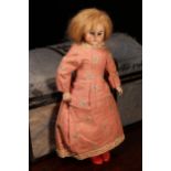 A bisque shoulder head doll, the bisque shoulder head inset with fixed blue glass eyes, painted