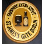 Advertising and Breweriana - an oval wooden Guinness wall plaque with Guinness glass and bottle