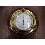 A brass and wood barometer
